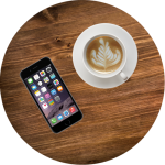 Photo of a macchiato and smartphone on table top